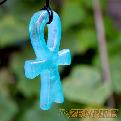 A translucent blue aura quartz Atlantis Ankh pendant hanging from a black cord