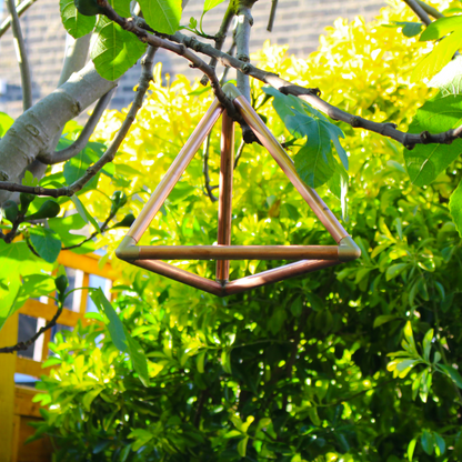 copper tetrahedron for self healing hanging from a tree
