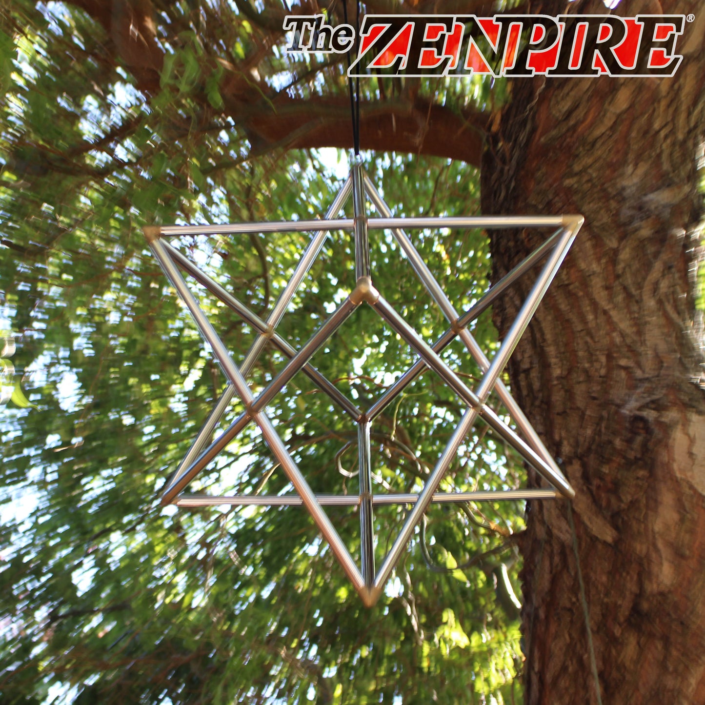 metallic chrome copper healing merkaba tantric star pyramid kit hanging from a tree