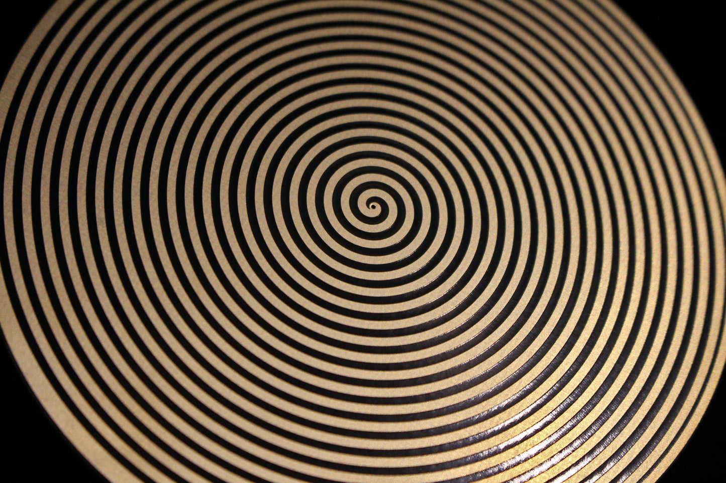 Close-up of a sacred spiral metallic healing disk 