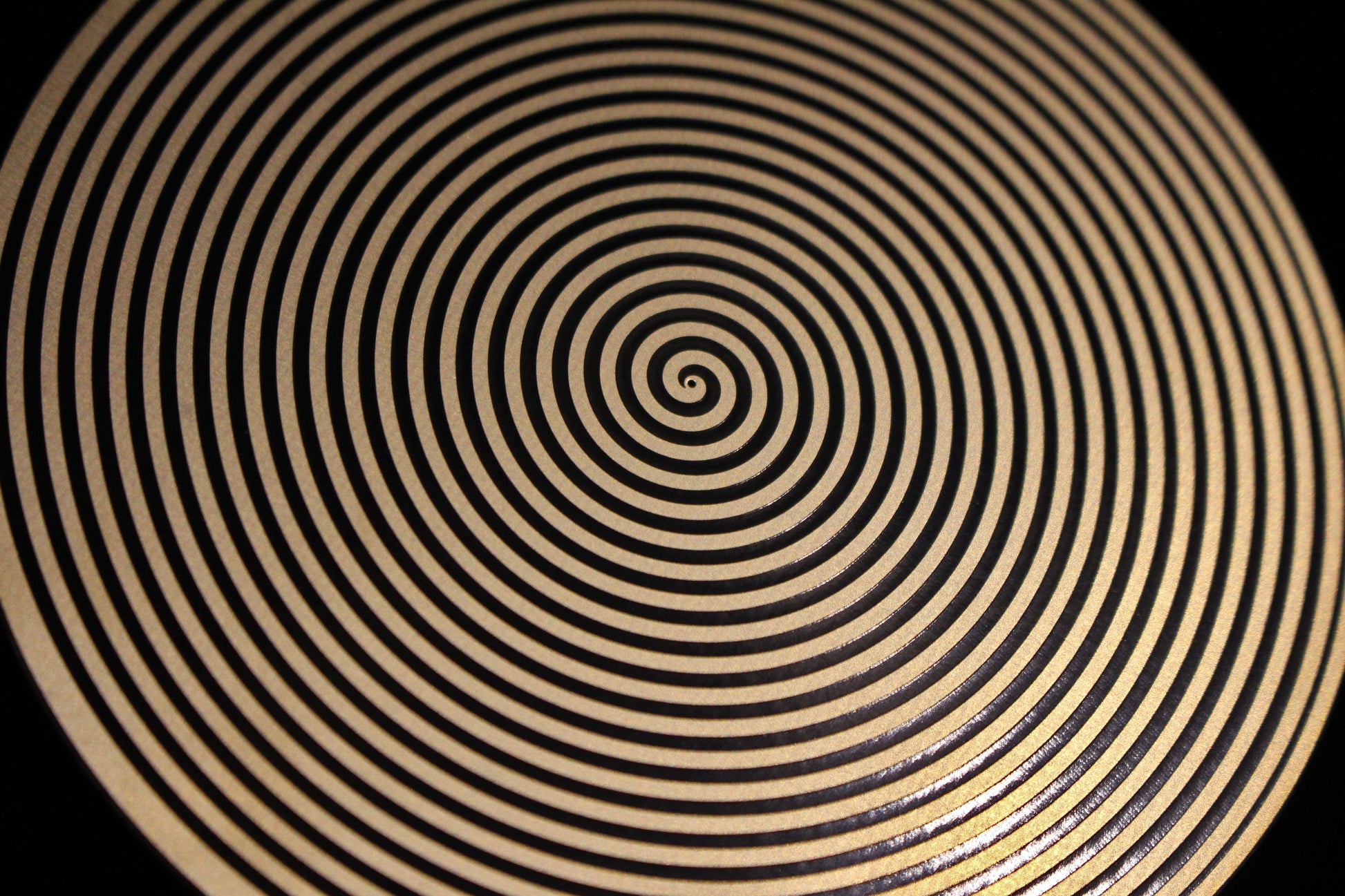 Close-up of a sacred spiral metallic healing disk 