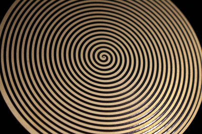 Close-up of a sacred spiral metallic healing disk 