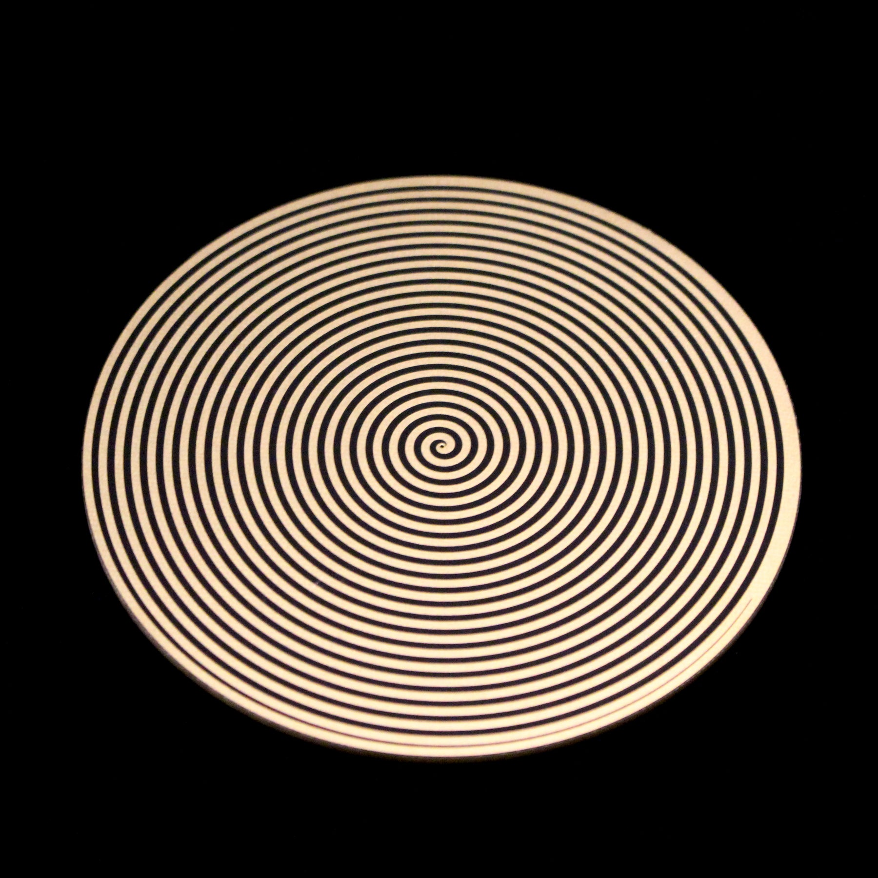 a metallic disk featuring a spiral pattern for elf healing