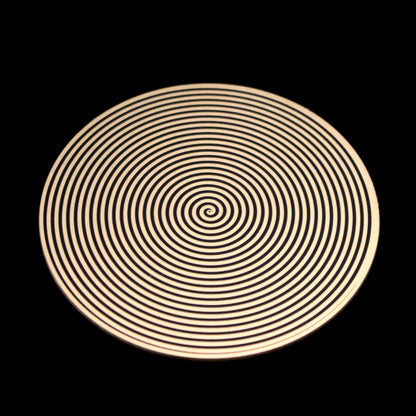 a metallic disk featuring a spiral pattern for elf healing
