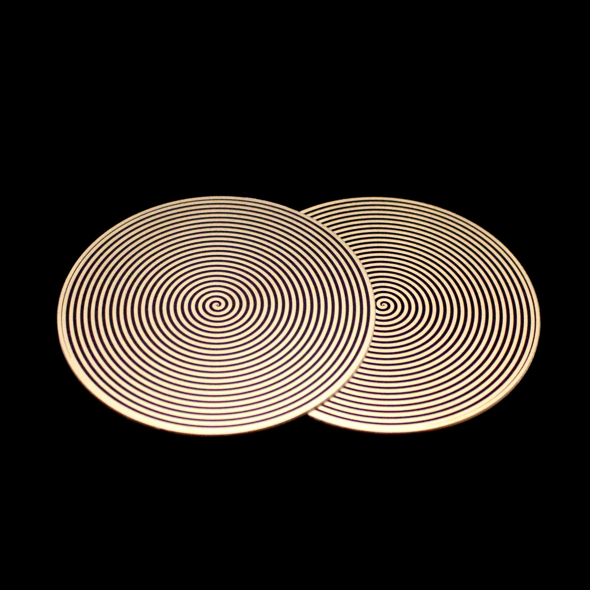 two metallic disk featuring a clockwise and counter-clockwise spiral pattern for elf healing