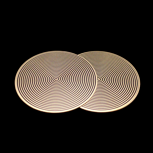 two metallic disk featuring a clockwise and counter-clockwise spiral pattern for elf healing